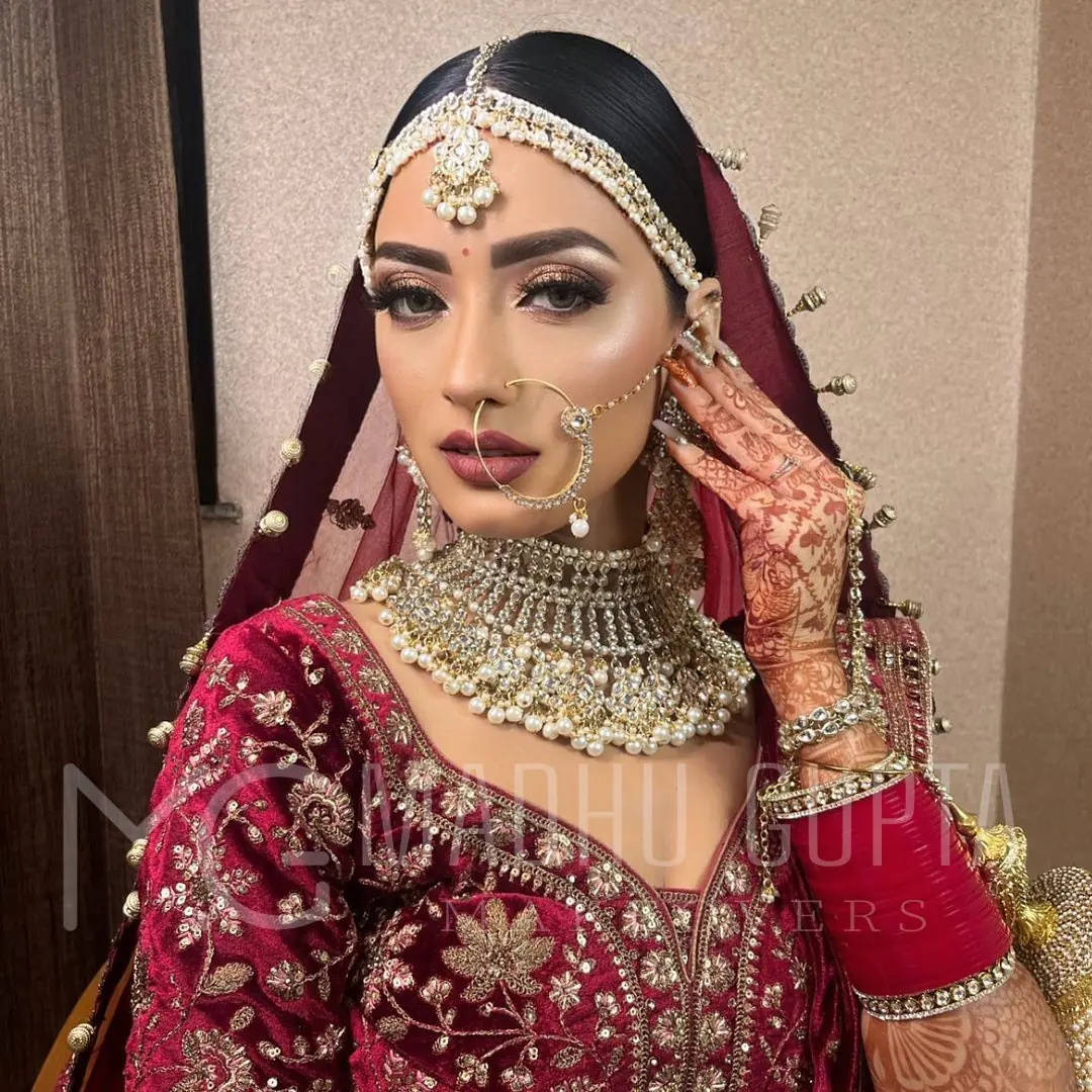 Maroon Lehenga, Mehendi Hand Raised. Bridal makeup by Madhu Gupta at MG Makeovers, Gurugram